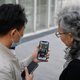 Chinese social media influencer and grandmother Ruan Yaqing, right, and her assistant Xie Xincun, left, reviewing a video intended for her channels on short-form video apps Kuaishou and Douyin in Beijing in April 2021.